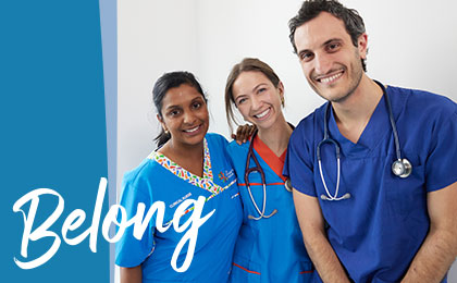 A nurse and two doctors smiling together with wording 'Belong.'